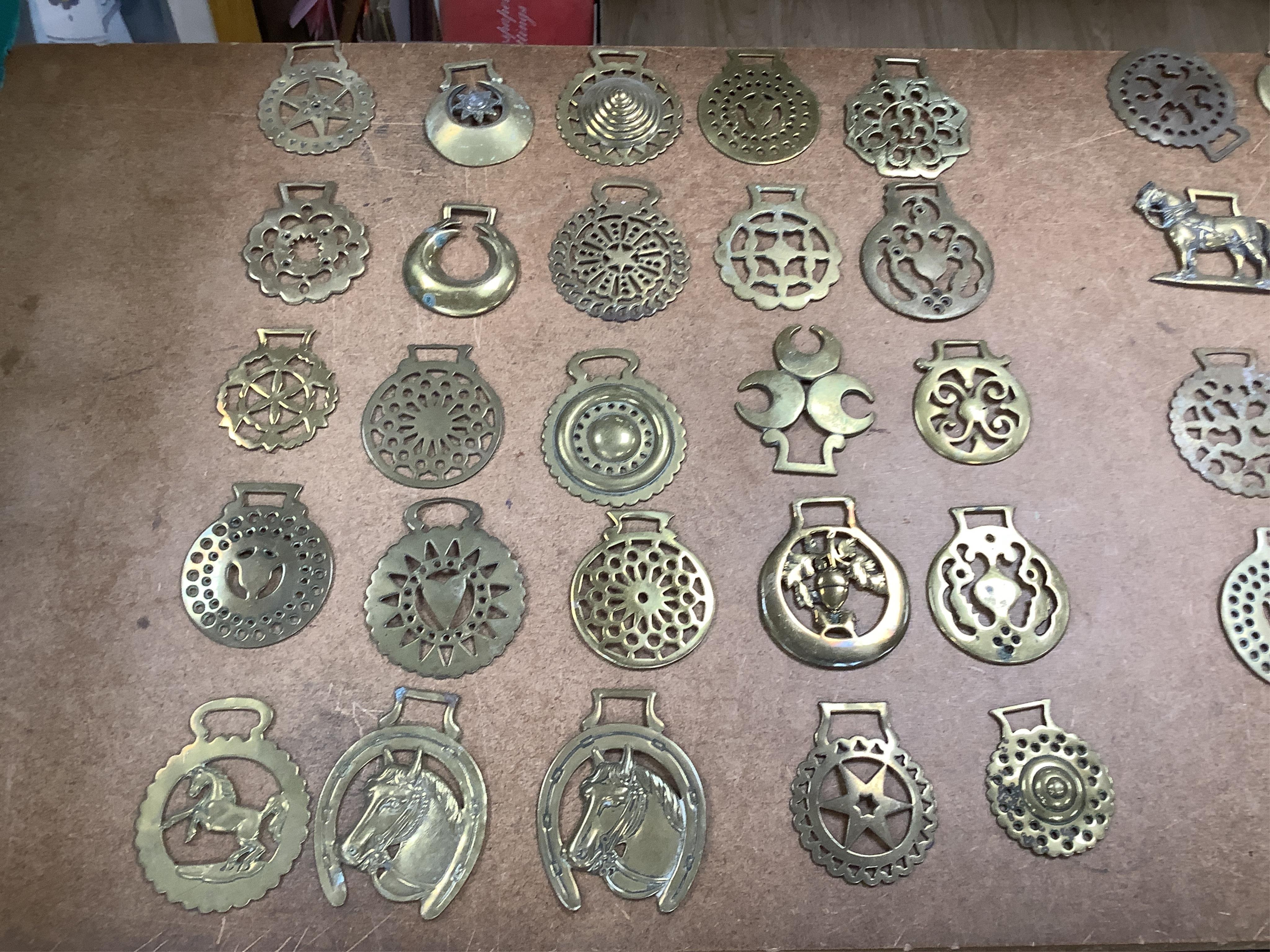 A collection of various horse brasses